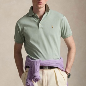 Model wearing Ralph Lauren Light Green Regular Polo with cream chinos and a lilac sweater tied at the waist.