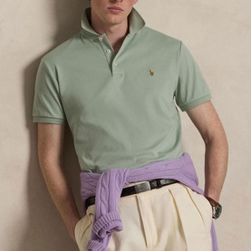 Model wearing Ralph Lauren Light Green Regular Polo with cream trousers and lilac jumper tied at waist