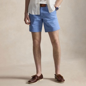 Model wearing Ralph Lauren Bristol Blue shorts, styled with a white shirt, brown leather belt, and tan boat shoes.