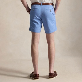 Model wearing Ralph Lauren Bristol Blue shorts with brown woven belt, styled with brown leather loafers. Rear view.