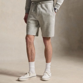 Model wearing Ralph Lauren dark sport heather fleece shorts with matching sweatshirt, white socks and cream trainers