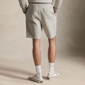 Model wearing Ralph Lauren Dark Sport Heather fleece shorts, back view, styled with matching grey sweatshirt and white trainers.