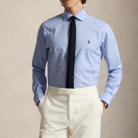 Model wearing Ralph Lauren Glen Plaid Poplin Shirt in Harbour Island Blue with navy tie and cream trousers