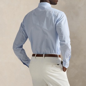 Model wearing Ralph Lauren Light Blue Single Cuff Regular shirt, rear view, styled with cream trousers and brown leather belt