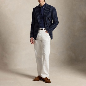 Model wearing Ralph Lauren Navy Slim Shirt under navy gold pinstripe blazer, styled with white trousers and tan suede loafers.