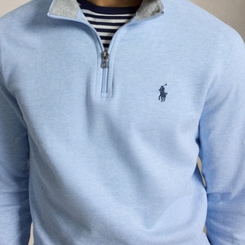 Model wearing Ralph Lauren office blue quarter-zip sweatshirt with grey collar, navy Polo Pony logo, styled over a striped top.
