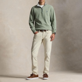 Model wearing Ralph Lauren green quarter-zip sweatshirt with cream chinos, white collar shirt and brown suede trainers.