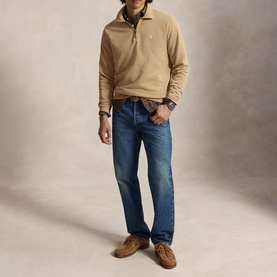 Model wearing Ralph Lauren vintage khaki half-zip sweatshirt, styled with mid-wash jeans and tan suede shoes