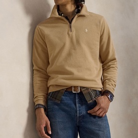 Model wearing Ralph Lauren Vintage Khaki quarter-zip sweatshirt with embroidered pony logo, styled with blue jeans and plaid shirt