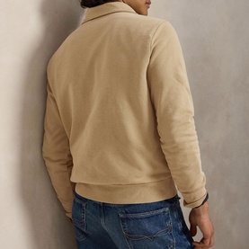 Model wearing Ralph Lauren vintage khaki sweatshirt, rear view, paired with blue jeans