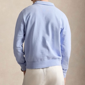 Model wearing Ralph Lauren Pebble Blue sweatshirt with collar detail, rear view, styled with cream trousers