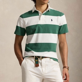 Model wearing Ralph Lauren striped polo shirt in antique green and oxford white, styled with cream trousers and woven belt