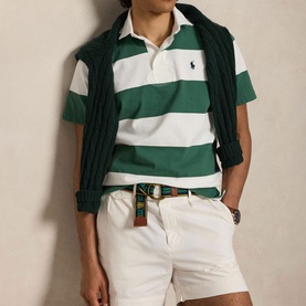 Model wearing Ralph Lauren Sweatshirt in Antique Green and Oxford White broad stripes, styled with white shorts and a dark knit vest.