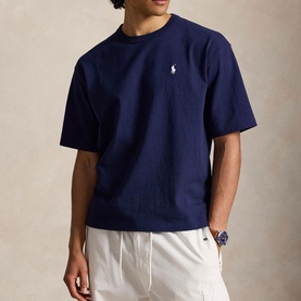 Model wearing Ralph Lauren Newport Navy crew-neck T-shirt with embroidered polo pony logo, styled with white trousers and blue watch