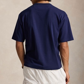 Model wearing Ralph Lauren Newport Navy T-shirt, rear view, styled with white shorts