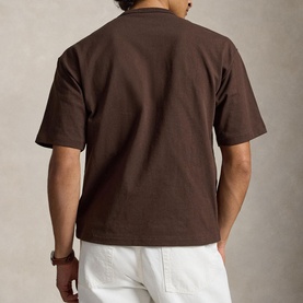Model wearing Ralph Lauren Nutmeg Brown T-shirt, rear view, styled with white trousers