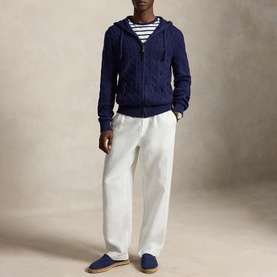 Model wearing Ralph Lauren bright navy cable-knit zip-through hoodie with white trousers and striped tee