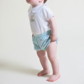 Model wearing Street Monkey 2 Piece set in white and turquoise, featuring embroidered top and gingham bloomers