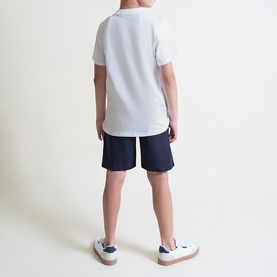 Model wearing Street Monkey White/Navy 2 Piece set, rear view, white polo shirt and navy shorts, styled with white trainers
