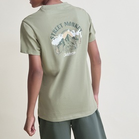 Model wearing Street Monkey green graphic back-print T-shirt, styled with matching green trousers, part of a 2-piece children's set.