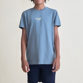 Model wearing Street Monkey blue crew-neck T-shirt with small chest graphic print, paired with navy trousers