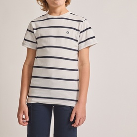 Model wearing Street Monkey white stripe T-shirt with navy horizontal stripes and small chest logo, styled with navy trousers