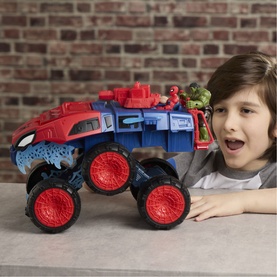 Child playing with Superheroes Spider-Man 2-In-1 Super Chompin' Tank, a large blue and red monster truck toy with oversized red wheels