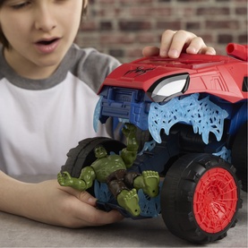 Boy playing with Superheroes Spider-Man 2-In-1 Super Chompin' Tank, red and blue monster truck toy with large black wheels and Hulk figures