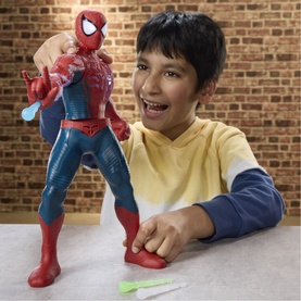 Superheroes Power-Charge Spider-Man action figure held by a child, red and blue, includes 3 accessories, one shown on table