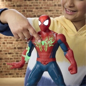 Superheroes Power-Charge Spider-Man action figure in red and blue, with green chest detail, held by a child against a brick wall background.