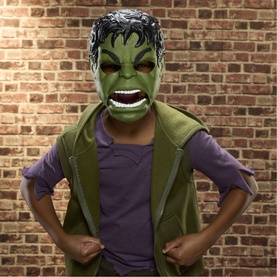 Child wearing Superheroes Savage Hulk Talk'n Electronic Mask, green Hulk face mask with open mouth, paired with olive vest over purple top