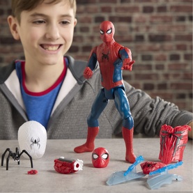 Superheroes Ultimate Web Gear Spider-Man action figure with accessories including spider, web, and mask displayed on table, boy in background