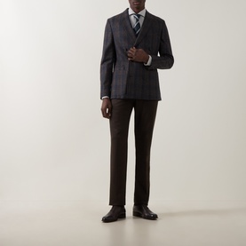 Model wearing Gherardi grey check blazer with brown trousers, striped tie and black leather dress shoes.