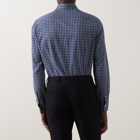 Model wearing Gherardi navy blue gingham check cotton casual shirt, shown from behind, styled with dark navy trousers.