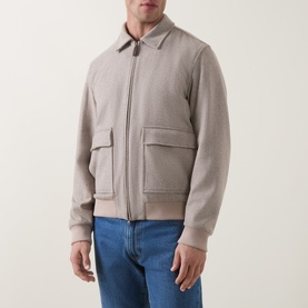 Model wearing Herno Cream Wool Cashmere Casual Jacket with zip front and patch pockets, styled with blue jeans.