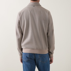 Model wearing Herno cream wool-cashmere casual jacket, rear view, styled with blue jeans.
