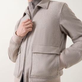 Model wearing Herno cream wool-cashmere casual jacket with zip fastening and patch pockets, close-up detail shot