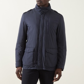 Model wearing Herno navy casual jacket with high collar, zip and press-stud fastening, and large front patch pockets.