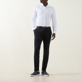 Model wearing Herno white cotton casual shirt with navy trousers, belt, and navy slip-on shoes.