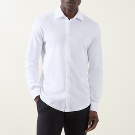 Model wearing Herno white cotton casual shirt with spread collar and button placket, styled with black trousers