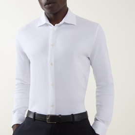Model wearing Herno white cotton casual shirt with spread collar and button placket, styled with navy trousers and black belt.