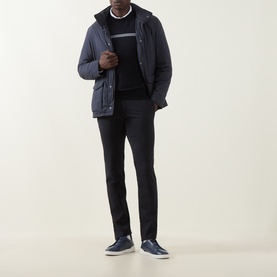 Model wearing Herno Contrast Stripe Crew Neck Sweater in dark blue with chest stripe, styled with navy jacket, trousers and navy trainers.