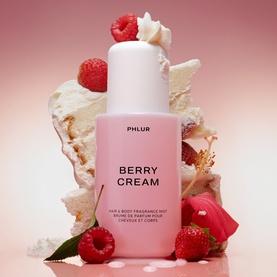 PHLUR Berry Cream Hair and Body Mist 240ml pink bottle surrounded by raspberries and cream, lifestyle shot