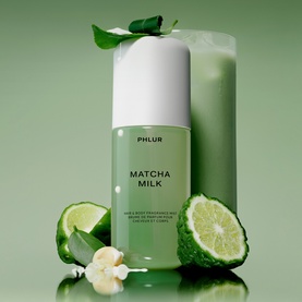 PHLUR Matcha Milk Hair and Body Mist 90ml in green bottle, styled with fresh matcha ingredients and citrus slices on green background