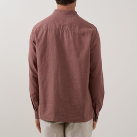 Model wearing Profuomo Garment-Dyed Overshirt in clay, rear view showing long sleeves and straight hemline in linen-cotton blend.