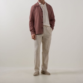 Model wearing Profuomo Clay Garment-Dyed Overshirt with pointed collar, styled with cream polo and taupe trousers