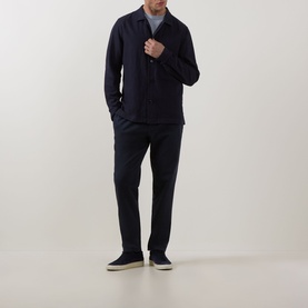 Model wearing Profuomo Navy Garment-Dyed Overshirt with matching navy trousers and dark slip-on shoes.