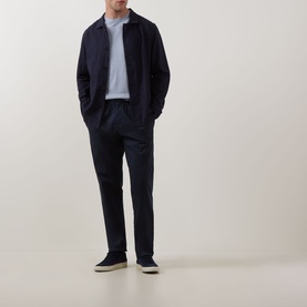 Model wearing Profuomo Navy Garment-Dyed Overshirt with pointed collar, styled with navy trousers and dark trainers.