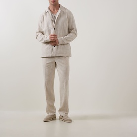 Model wearing Profuomo Notched Collar Overshirt in beige linen-cotton, styled with matching trousers and cream loafers