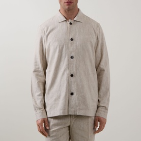 Model wearing Profuomo Notched Collar Overshirt in beige, featuring notched collar, dark buttons, and long sleeves, styled with matching beige